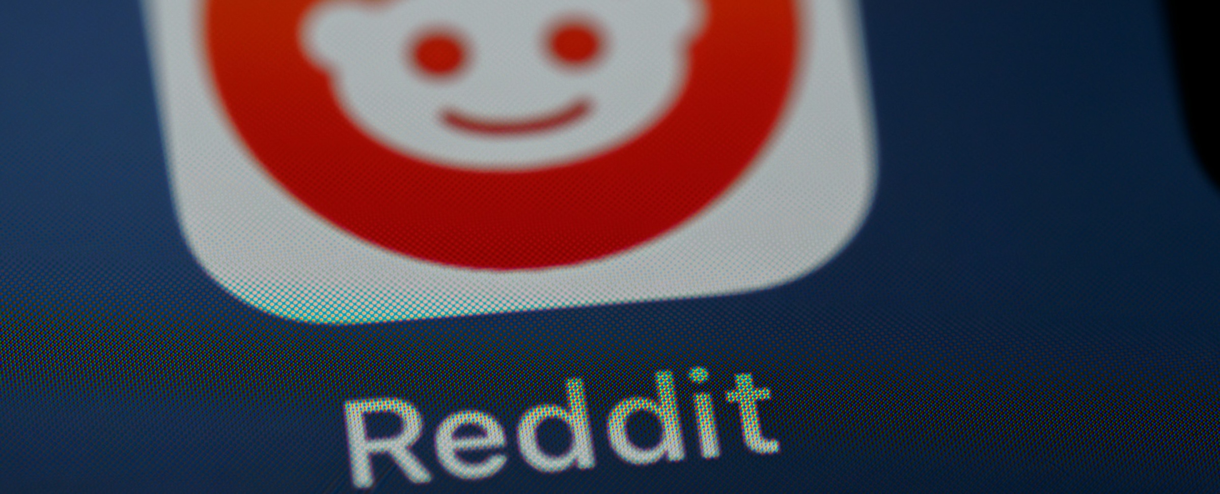 Photograph of the Reddit app icon on a smartphone