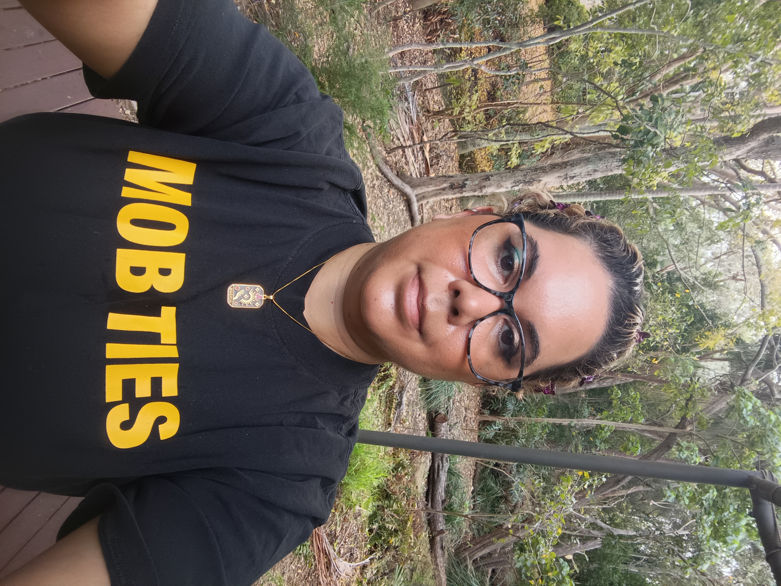 Blanche on country in Bundaberg, Gooreng Gooreng Traditional Owner A selfie of Blanche in an outdoor space wearing a t-shirt that says 'mob ties'.