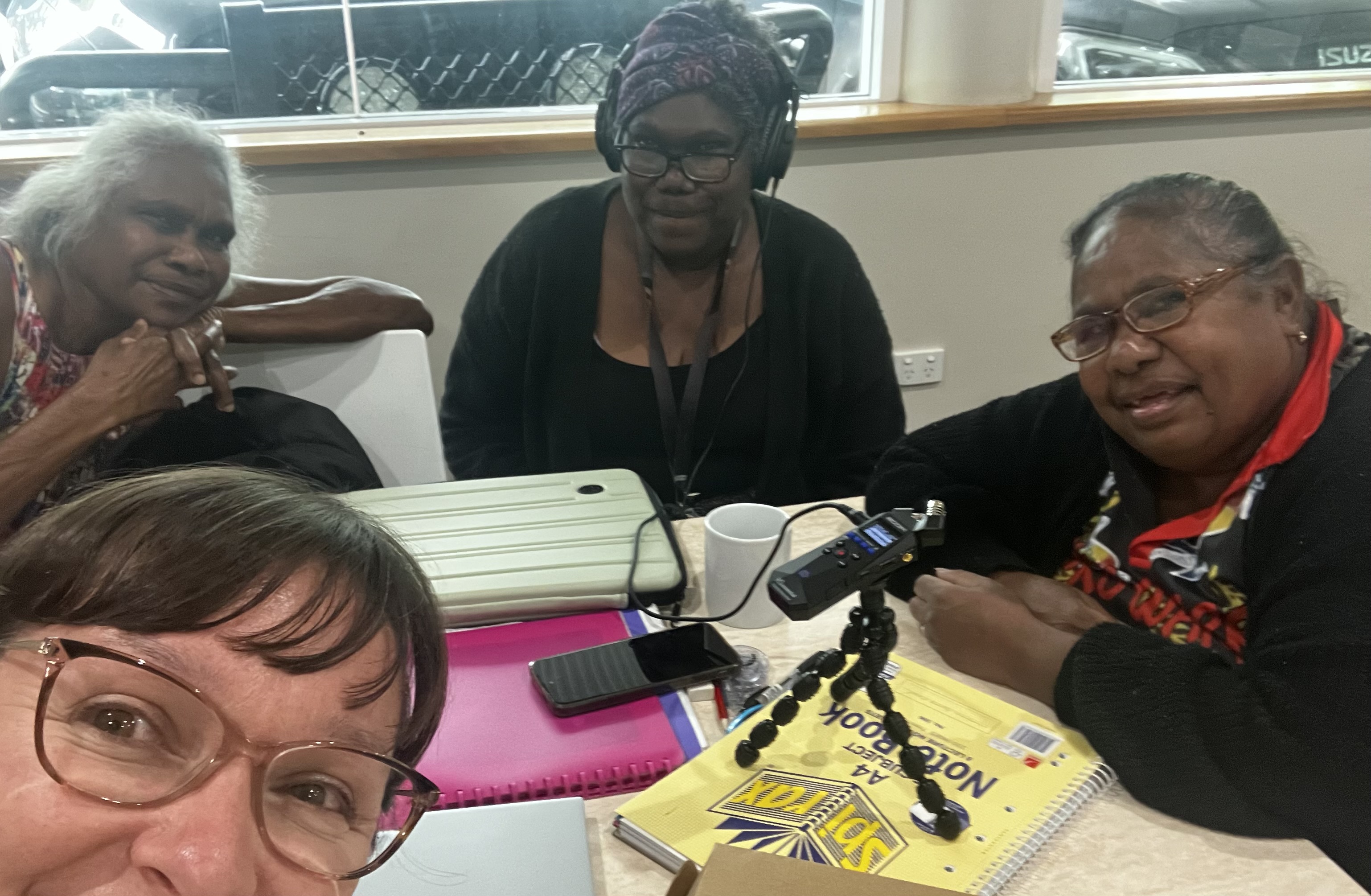Kunjen Elders practicing audio recording techniques with Katie Four women sitting around a table with recording equipment