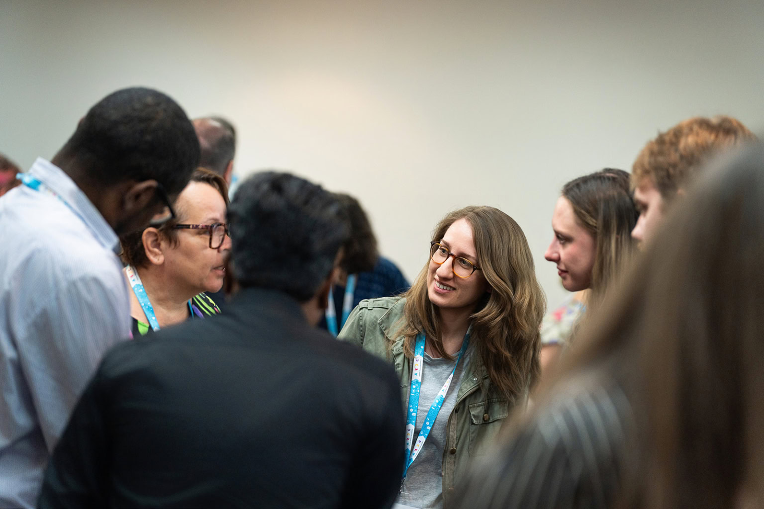 Rosanna Smith smiling mid-conversation in a group of people