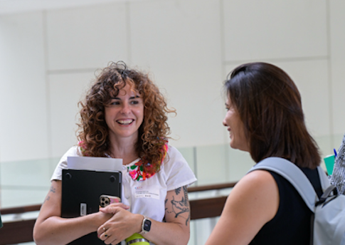 Chenoa, left, at ARDC's HASS and Indigenous Research Data Commons Summer School in February 2025. A photograph of a group of people talking